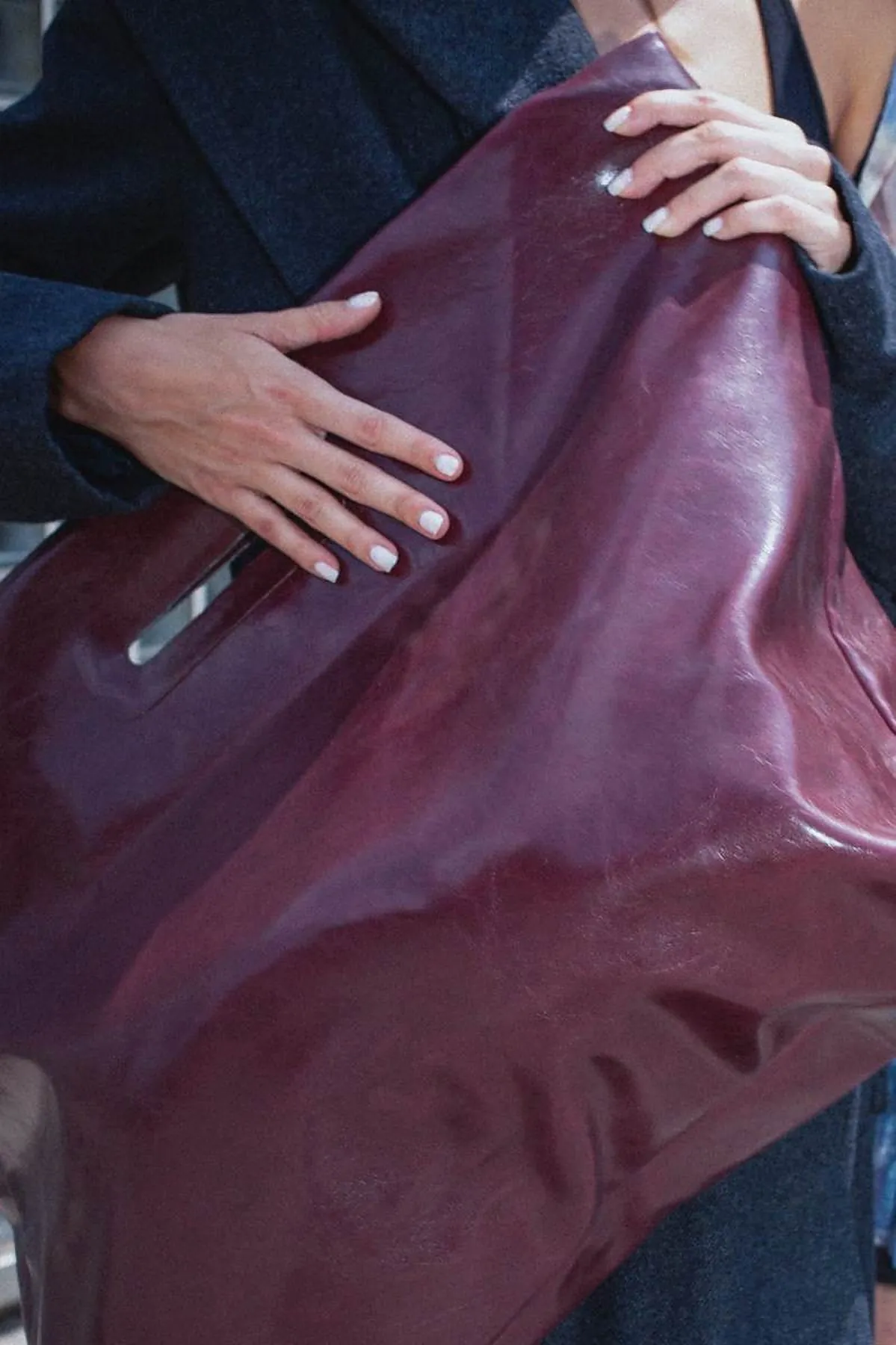 Detail of a burgundy leather bag